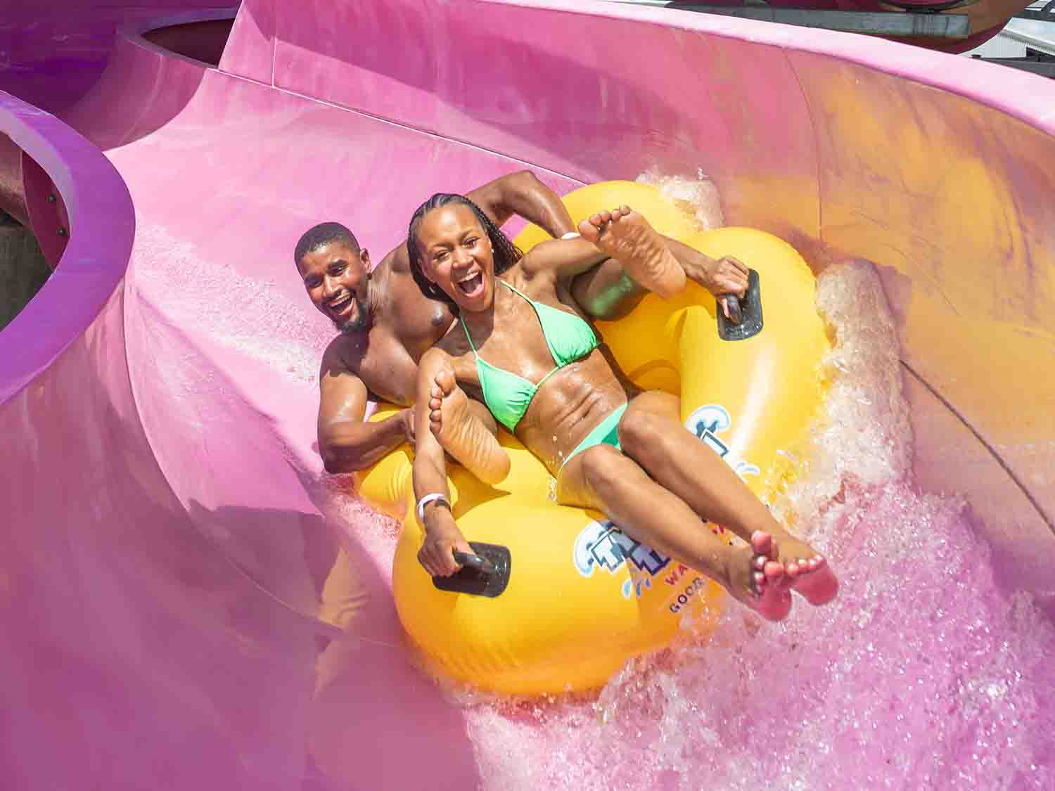 People sliding on a water slider
