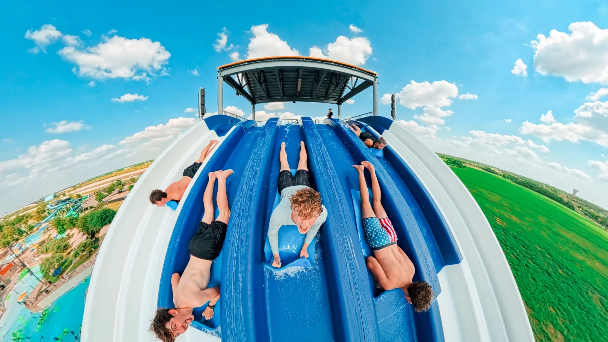 Kids going down a water slide.